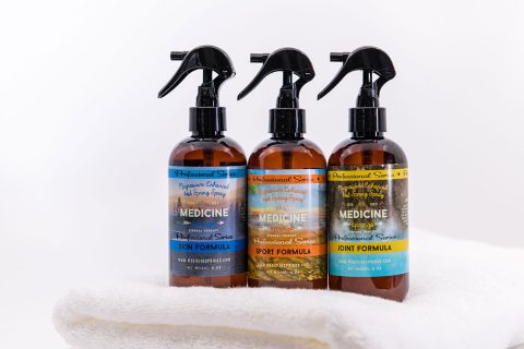 Three spray bottles of Medicine Springs mineral therapy professional series hot spring spray. These are the Skin Formula, Sport Formula, and Joint Formula resting on a towel.