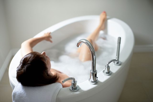 top view of a serene mature woman in a bathtub